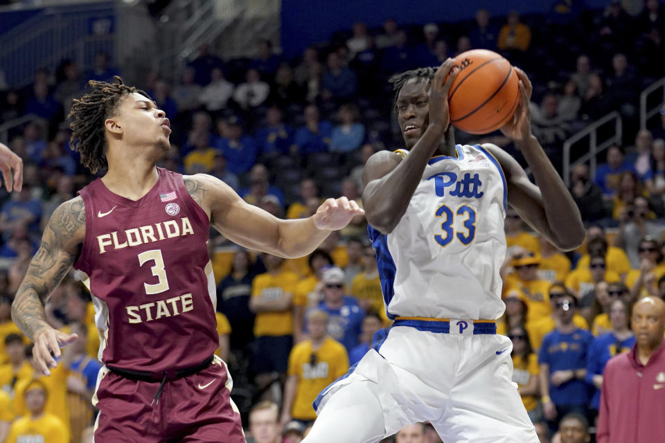 Pittsburgh's Federiko Federiko (33) pulls down a rebound against Florida State's Cam Corhen (3) during the first half of an NCAA college basketball game Tuesday, March 5, 2024, in Pittsburgh. (AP Photo/Matt Freed)