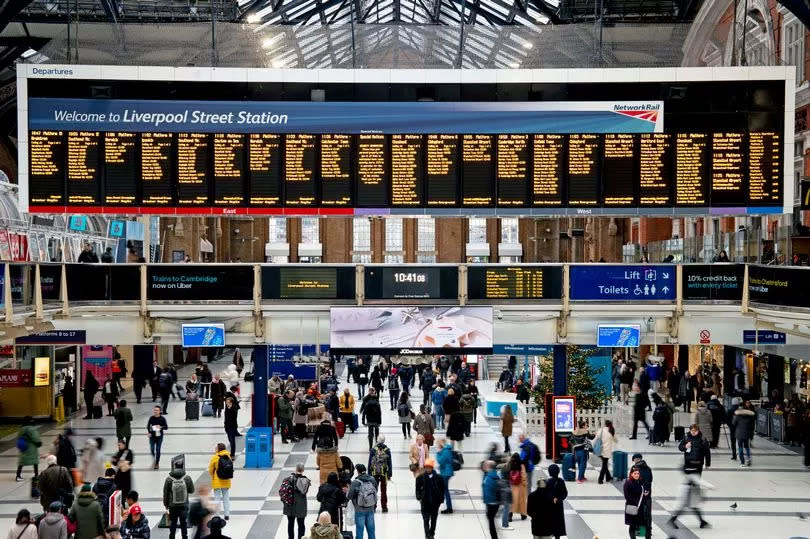 Passengers wait on the concourse at Liverpool Street station in London - Labour has pledged to renationalise the railways if elected