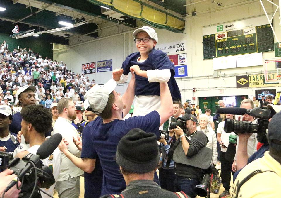 Dylan Schaeffler, an official member of the Catamounts team thru the Team IMPACT program, gets lifted up during the post game celebration after Vermont's 72-59 win over UMass Lowell in the America East title game on Saturday afternoon at Patrick Gym.