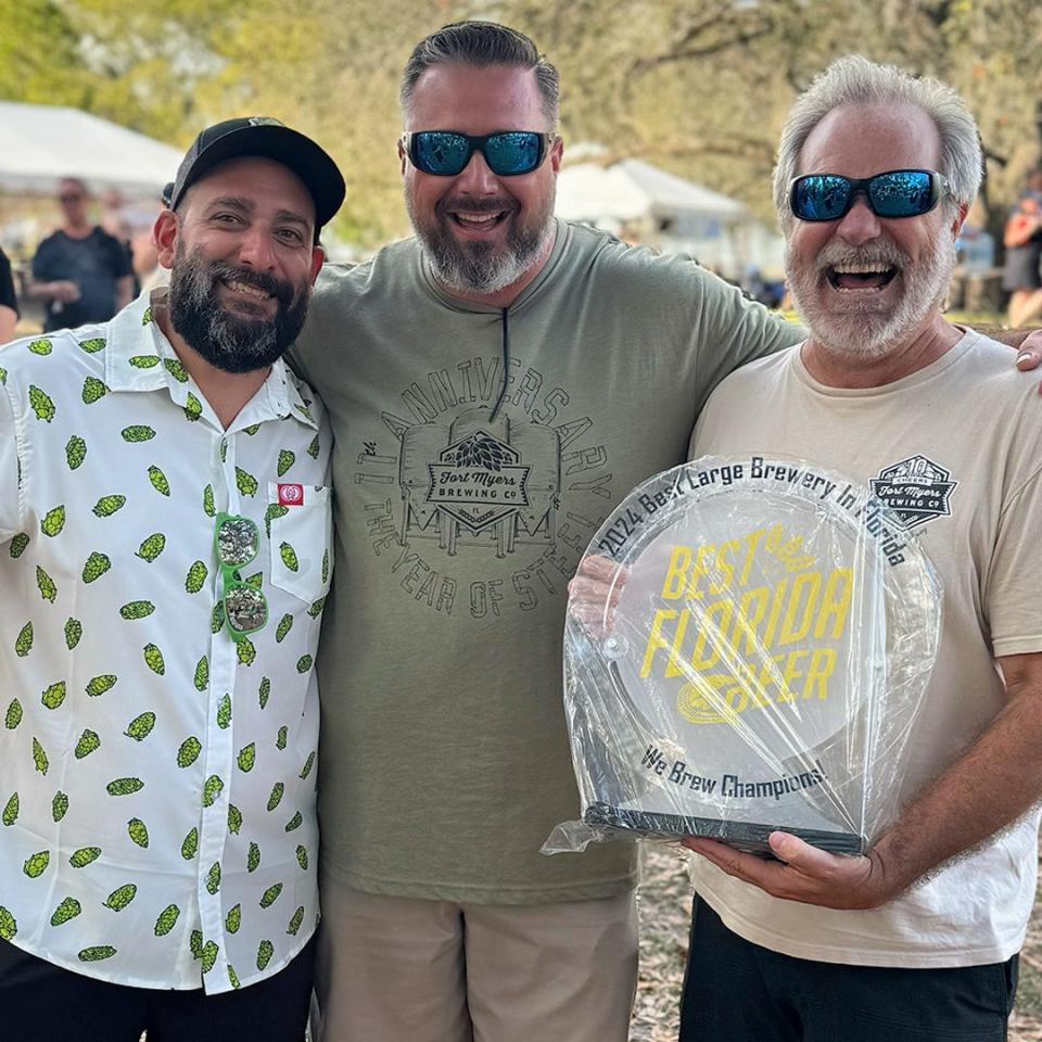Co-owner Rob Whyte, right, celebrates Fort Myers Brewing being named Florida's Best Large Brewery at the 2024 Best Florida Beer Brewer’s Ball with head brewer Anthony Coronato, left, and TJ Jewell, VP of operations.