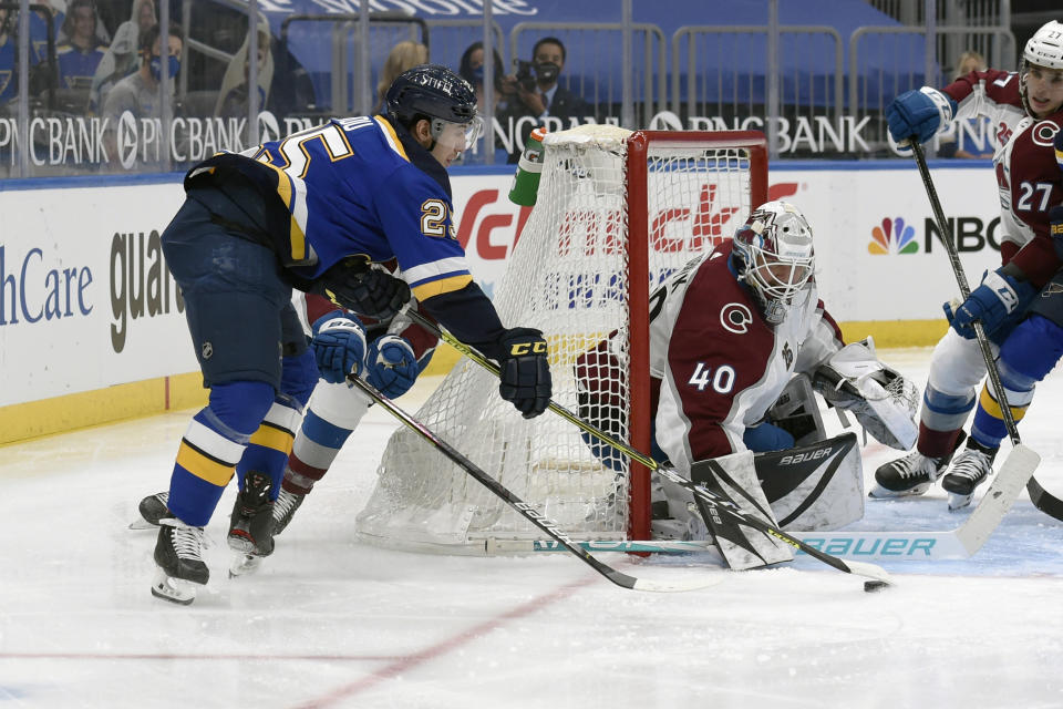 Colorado Avalanche's Devan Dubnyk (40) defends the net against St. Louis Blues' Jordan Kyrou (25) during the second period of an NHL hockey game on Wednesday, April 14, 2021, in St. Louis. (AP Photo/Joe Puetz)