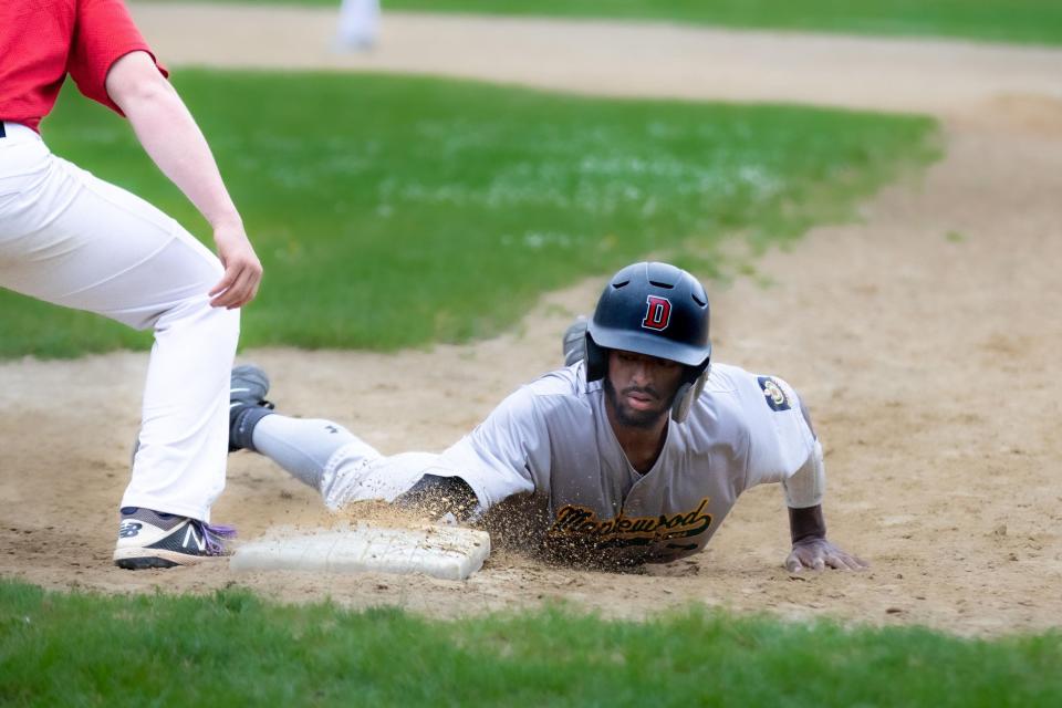 Maplewood Post 464's Alexis Montilla slides back safely in last week's game against Kingston Post 387.