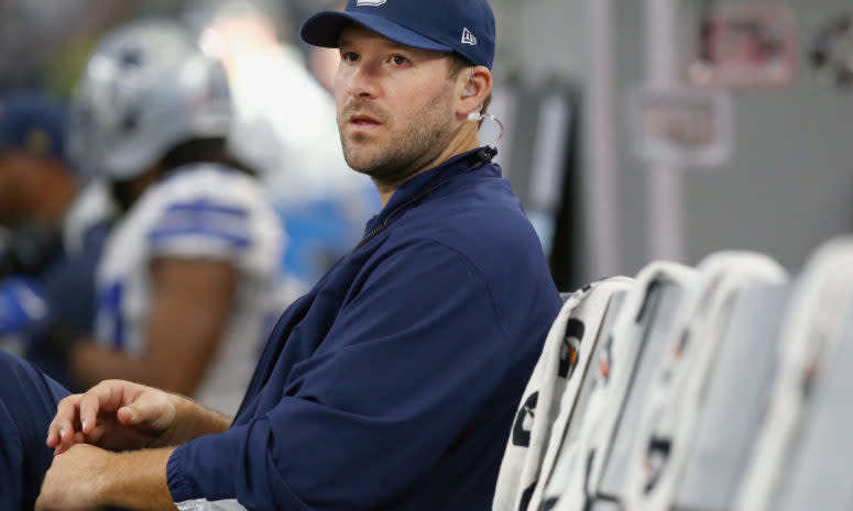 tony romo sits on the sideline during a game against the redskins