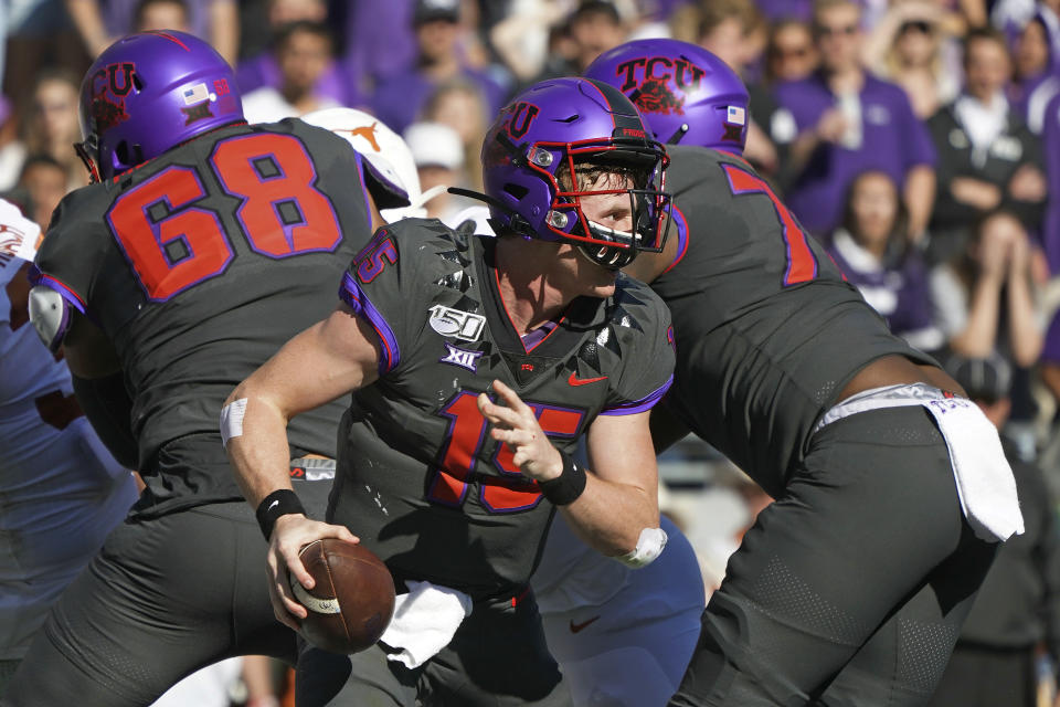 TCU quarterback Max Duggan (15) scrambles out of the pocket in the first half of an NCAA college football game against Texas in Fort Worth, Texas, Saturday, Oct. 26, 2019. (AP Photo/Louis DeLuca)