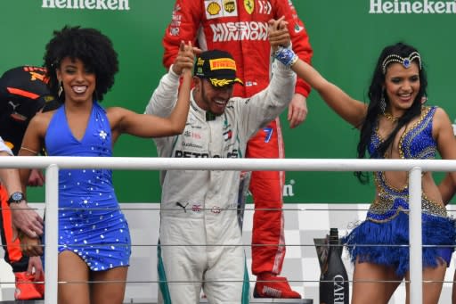 Lewis Hamilton celebrates on the podium after winning the Brazil Grand Prix