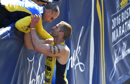 Matthew Cox, of Wells, Maine, talks with Bill Richard, whose son Martin Richard was killed in the 2013 Boston Marathon bombings, after Cox crossed the finish line of the 120th running of the Boston Marathon in Boston, Massachusetts April 18, 2015. REUTERS/Gretchen Ertl
