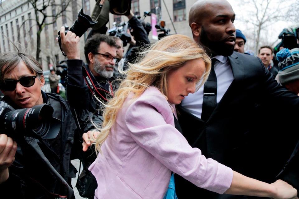 Stormy Daniels is mobbed by the media outside a New York federal court in 2018 (AP)