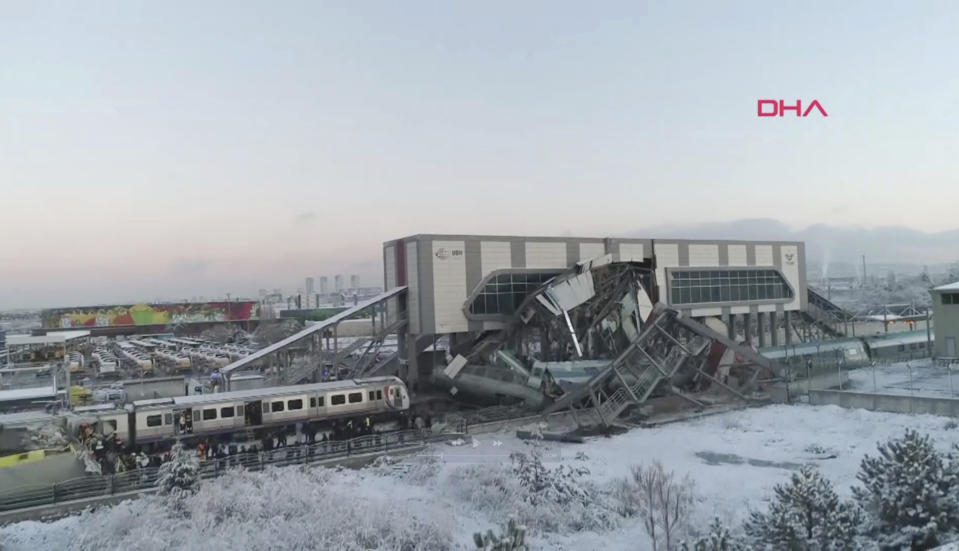 This image made from video shows aftermath of a high-speed train crash at a station in Ankara, Turkey, Thursday, Dec. 13, 2018. The train hit a railway engine and crashed into a pedestrian overpass at the station on Thursday. (DHA via AP)