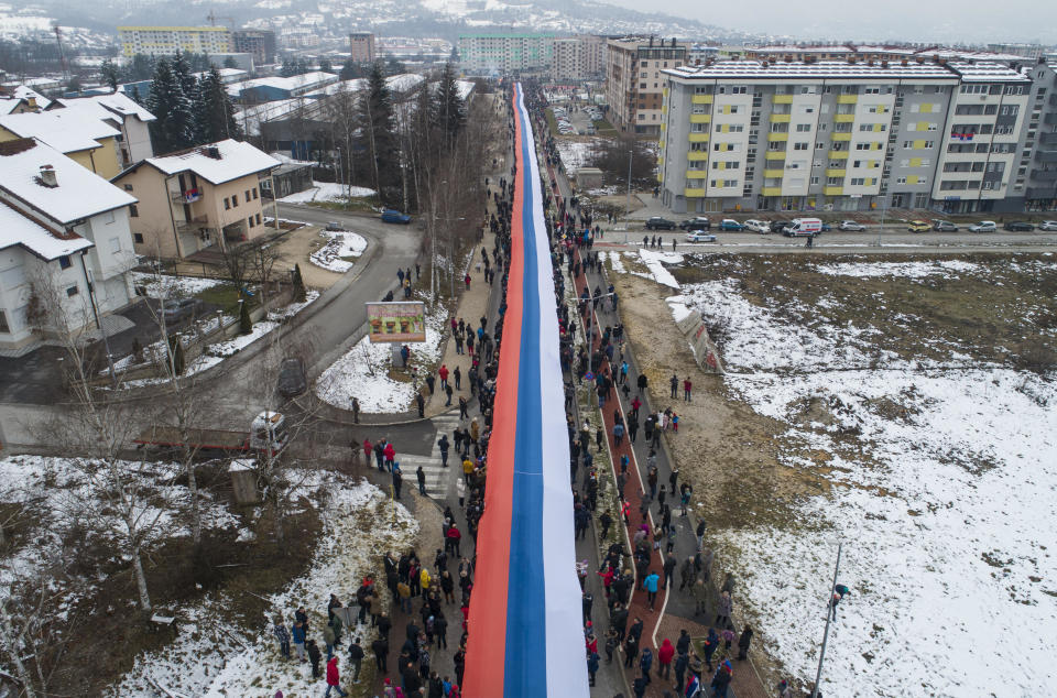 Bosnian Serbs march carrying a giant Serbian flag in Sarajevo, Bosnia, Sunday, Jan. 9, 2022.  / Credit: / AP