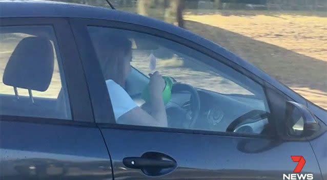 A P-plater was photographed eating her breakfast while driving. Source: 7 News