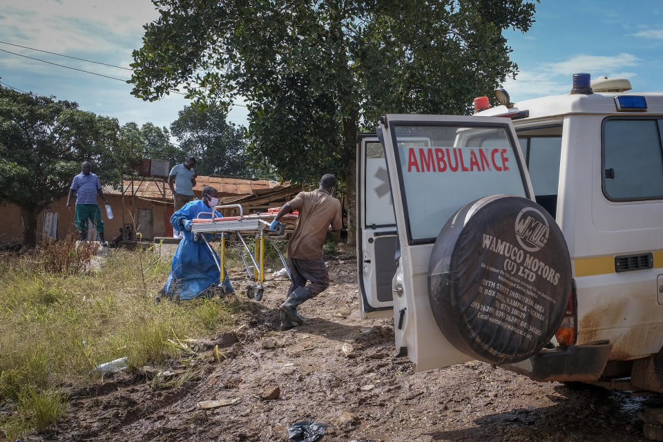 Men carry a stretcher used for suspected Ebola victims back to an ambulance after washing it, in the town of Kassanda in Uganda Tuesday, Nov. 1, 2022. Ugandan health officials say they have controlled the spread of a strain of Ebola that has no proven vaccine, but there are pockets of resistance to health measures among some in rural communities where illiteracy is high and restrictions on movement and business activity have left many bitter. (AP Photo/Hajarah Nalwadda)