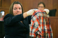 State Police forensic scientist Sherri Menendez holds up a shirt recovered from from the body of Odin Lloyd during the murder trial for former NFL player Aaron Hernandez in Fall River, Massachusetts, March 4, 2015. REUTERS/Dominick Reuter/Pool