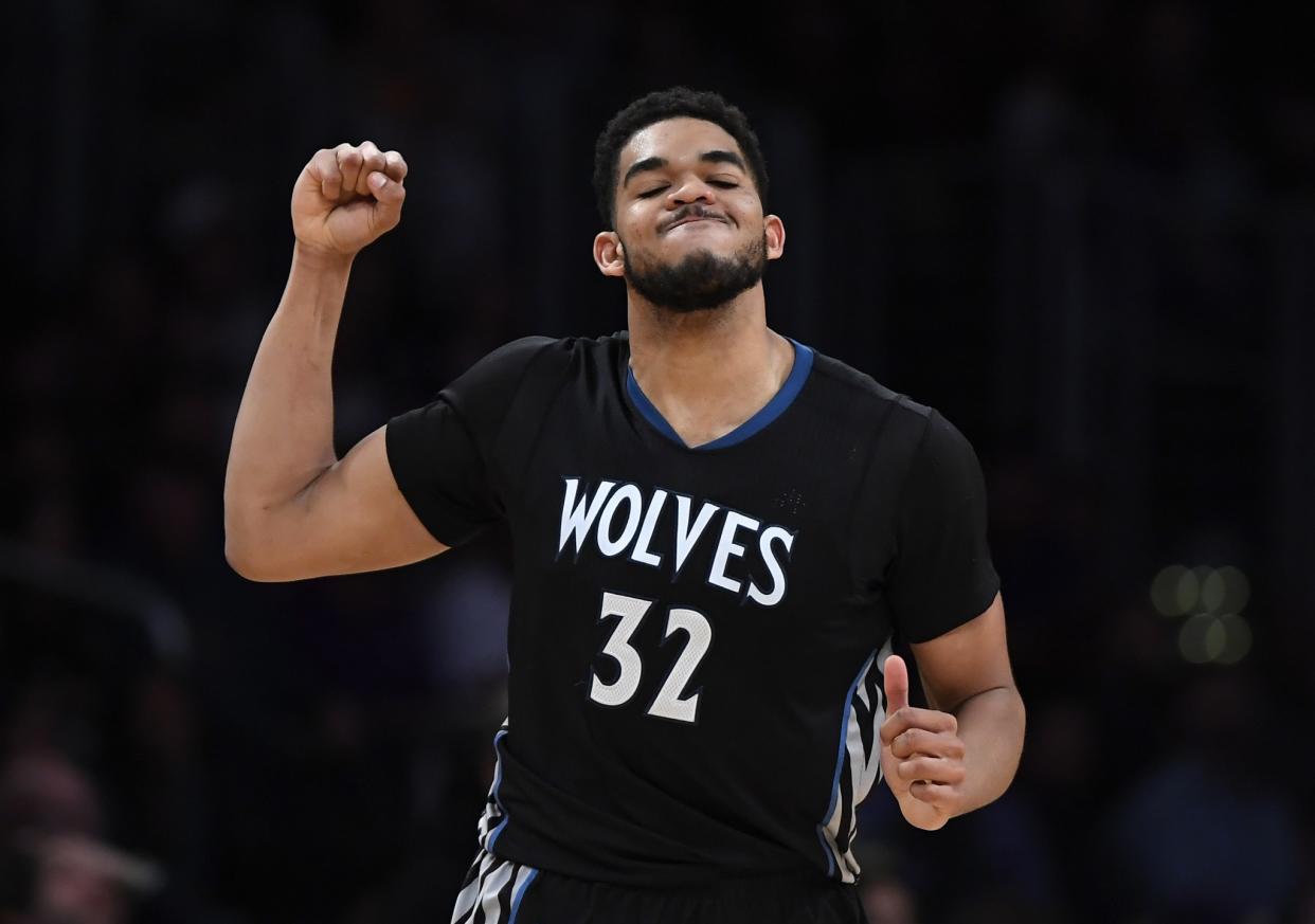 Karl-Anthony Towns pumps his fist in exultation at the thought of sweet, sweet Fitbit jersey-ad money coming into his organization. (AP)