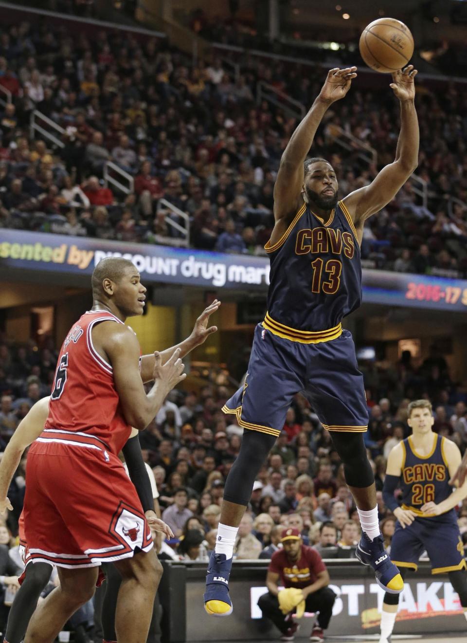 Cleveland Cavaliers' Tristan Thompson (13) passes the ball away from Chicago Bulls' Cristiano Felicio (6) during the second half of an NBA basketball game, Saturday, Feb. 25, 2017, in Cleveland. (AP Photo/Tony Dejak)