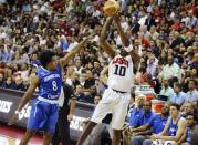 In this photo provided by the Las Vegas News Bureau, United States Olympic men's basketball team member Kobe Bryant (10) shoots a 3-pointer against the Dominican Republic during an exhibition game, Thursday, July 12, 2012, in Las Vegas. The U.S. won 113-59. (AP Photo/Las Vegas News Bureau, Brian Jones)