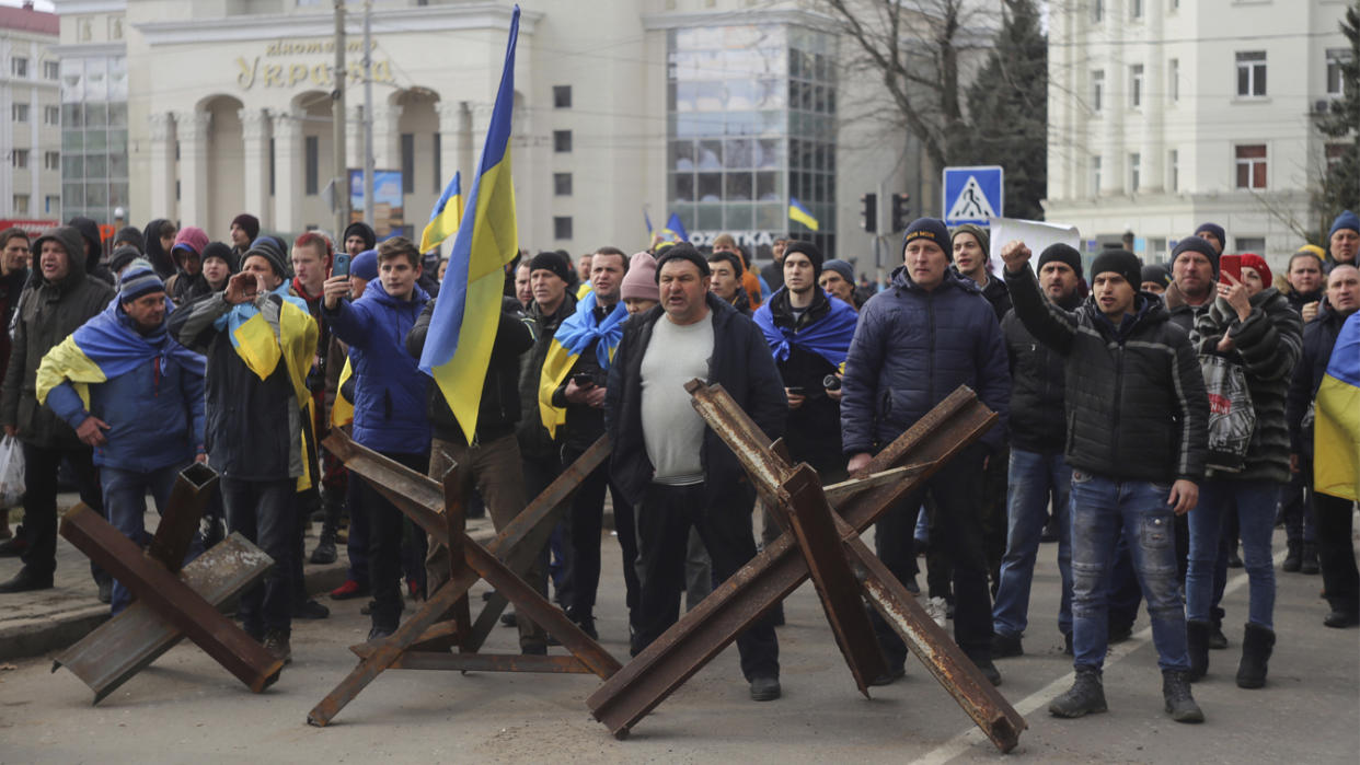 People shout toward Russian army soldiers during a rally against the Russian occupation in Svobody (Freedom) Square in Kherson, Ukraine, Monday, March 7, 2022. (Olexandr Chornyi/AP Photo)