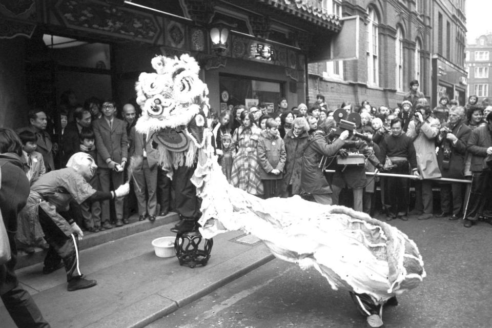 Crowds in Gerrard Street wait for the start of the lion dance, part of the Chinese New Year Festival in 1973 (PA)