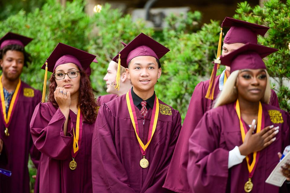 Members of St. Augustine High School’s class of 2022 walk into the St. Augustine Amphitheatre at the start of their commencement ceremony on Thursday, May 26, 2022.