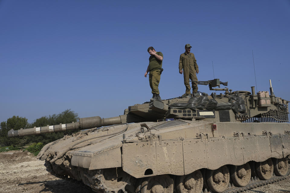 Israeli soldiers stand on their tank in a staging area near the Israel-Gaza border in southern Israel, Wednesday, Feb. 28, 2024. (AP Photo/Tsafrir Abayov)