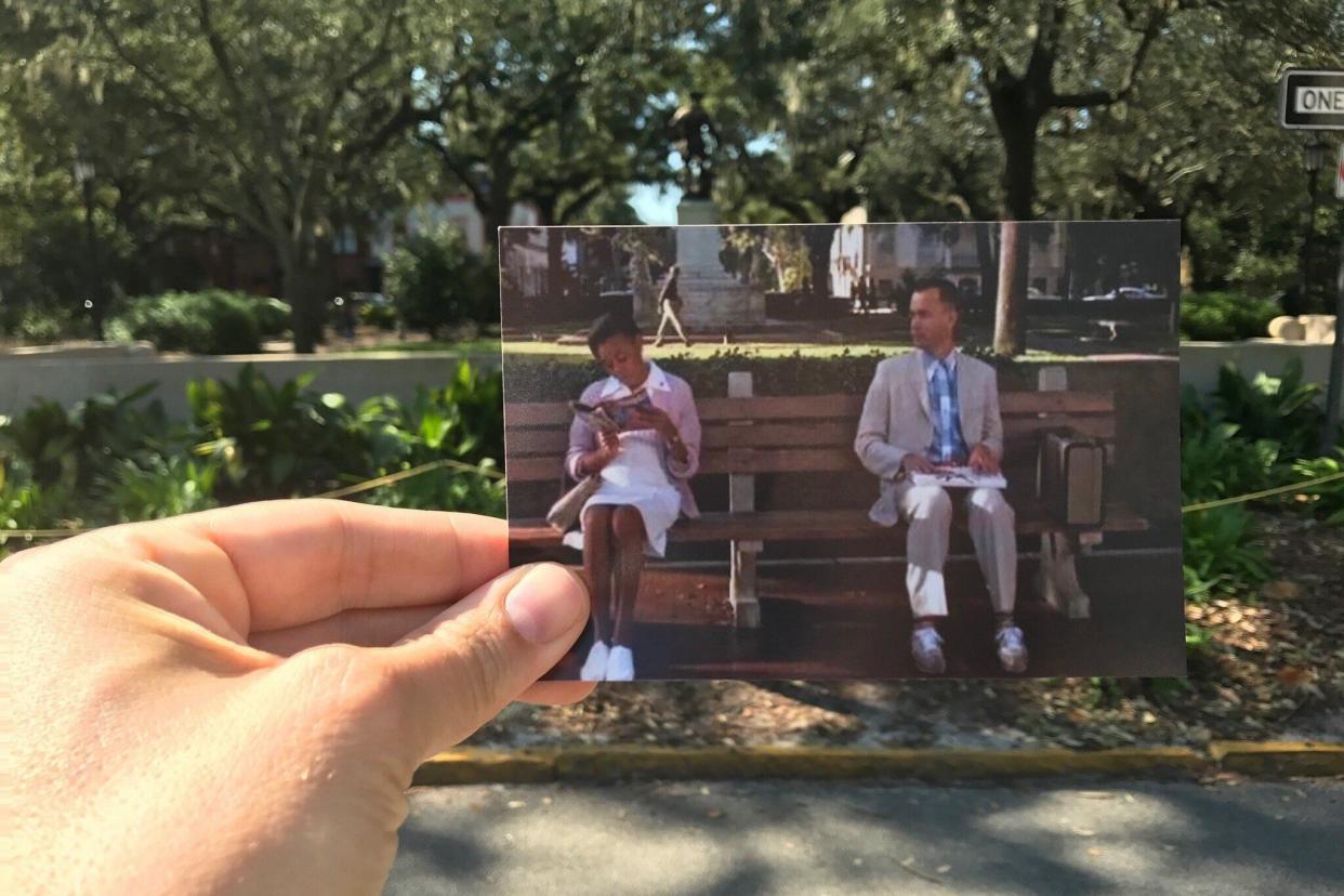 The Bench at Chippewa Square, Savannah, Georgia, hand holding up a photo from 'the bench' scene in the Forrest Gump movie