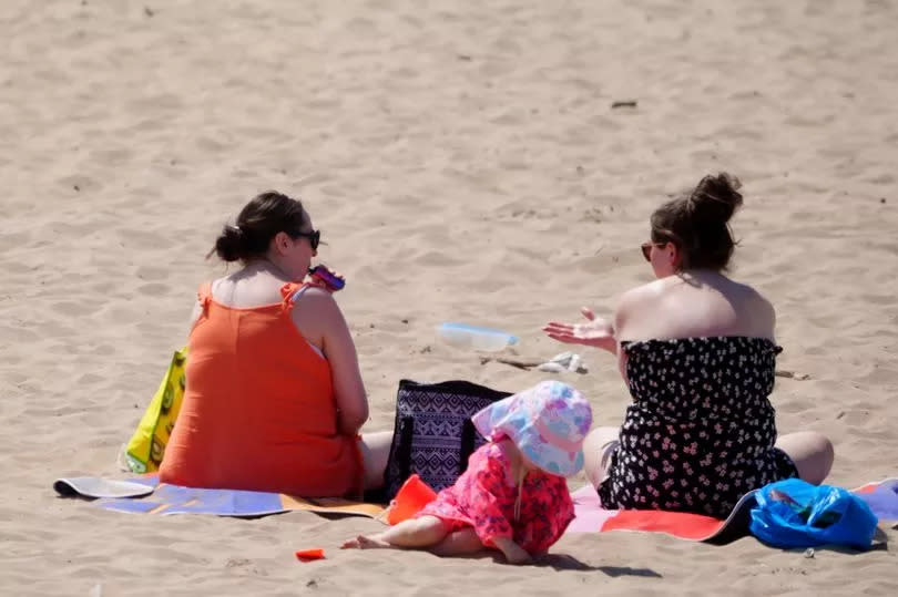 Generic images of people relaxing at a beach in England