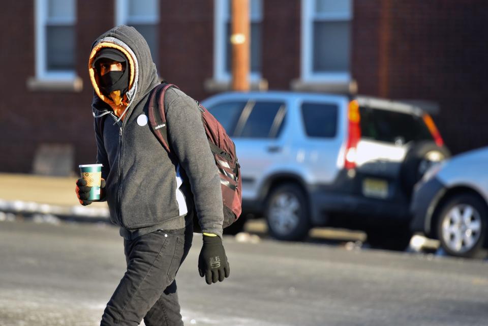 A man is bundled up against the cold on Wednesday morning while walking on Gregory Ave. in Passaic.