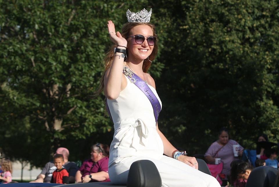 Iowa State Fair Queen Mary Ann Fox waves to the crowd on Grand Avenue in Des Moines during the Iowa State Fair Parade on Wednesday.