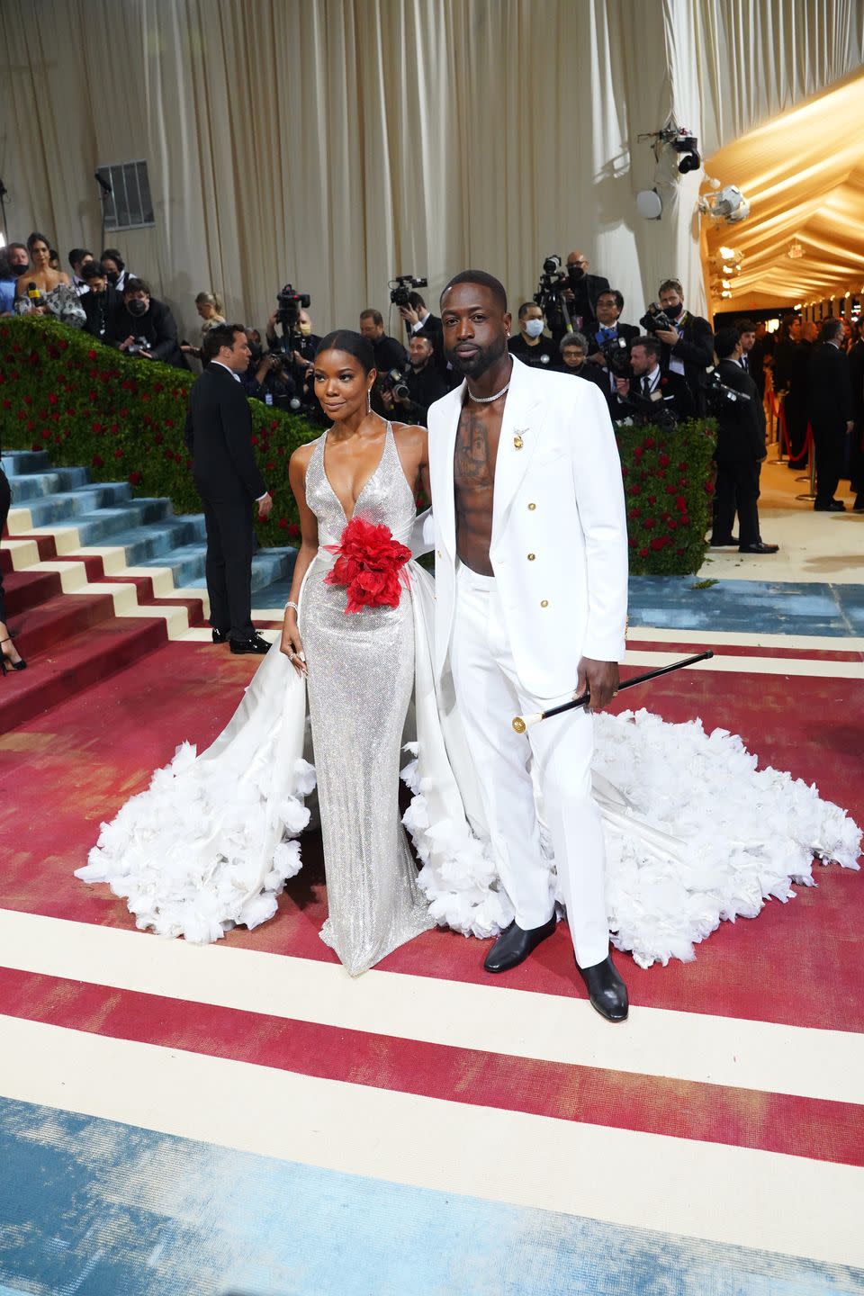 gabrielle union and dwayne wade posing for a photo in all white and silver versace at the 2022 costume institute benefit in america an anthology of fashion