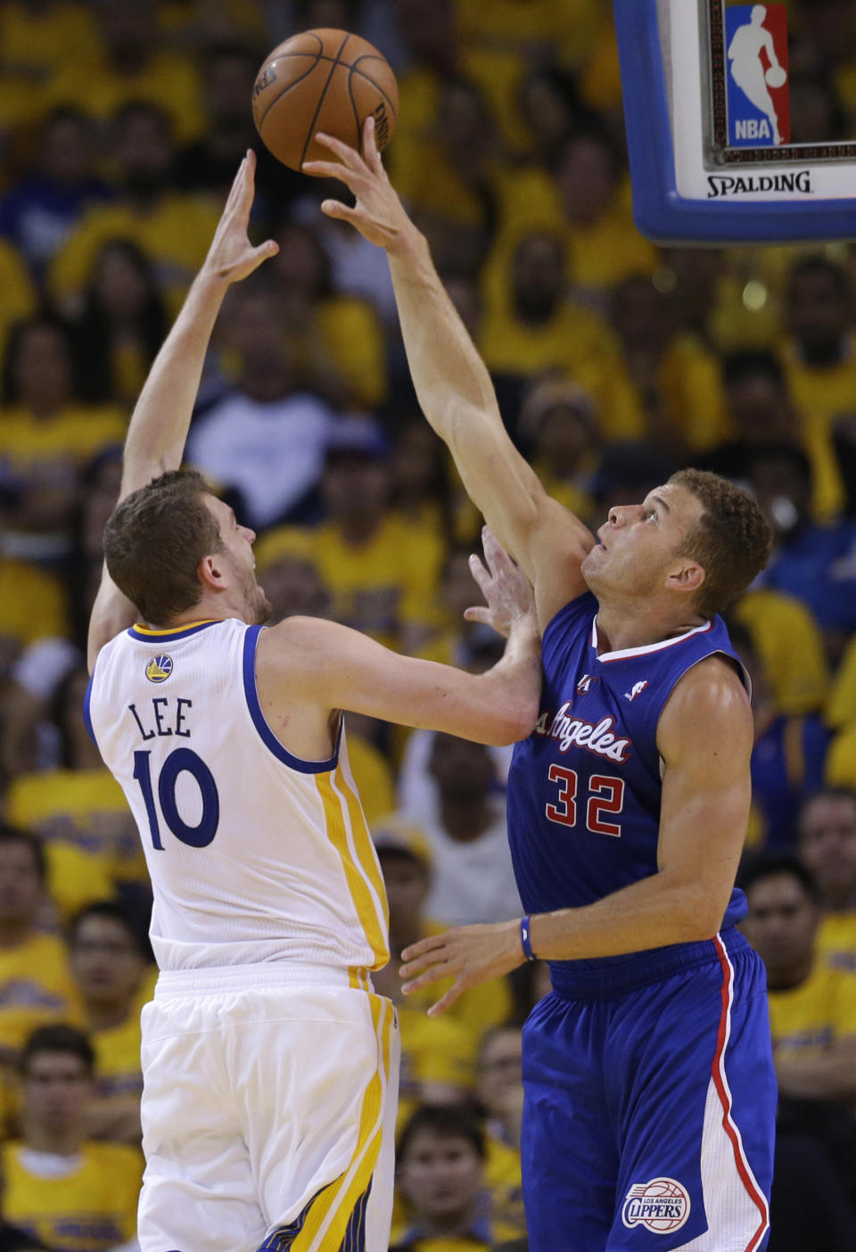 Los Angeles Clippers' Blake Griffin, right, blocks a shot from Golden State Warriors' David Lee (10) during the first half in Game 3 of an opening-round NBA basketball playoff series, Thursday, April 24, 2014, in Oakland, Calif. (AP Photo/Marcio Jose Sanchez)