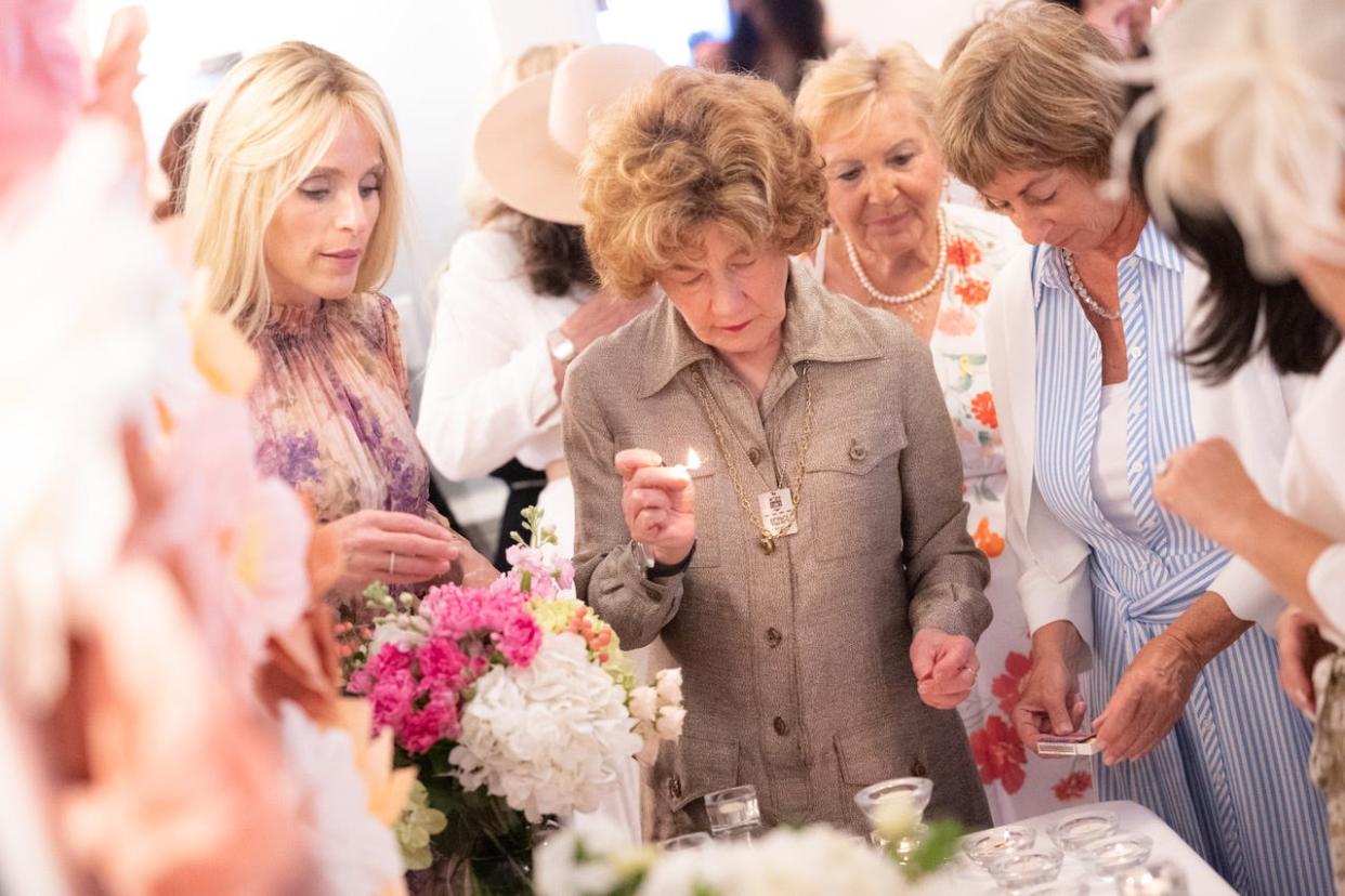 Dinie Scheiner (left) of Palm Beach Synagogue leads a prayer during a bat mitzvah celebration for 18 women on April 12.