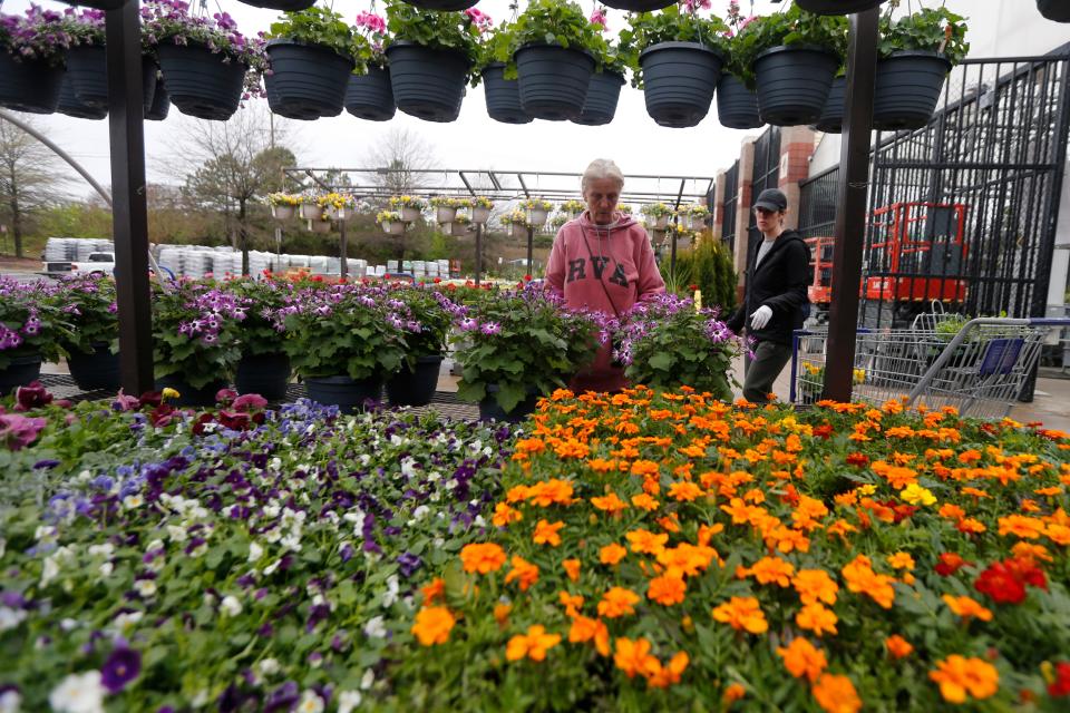 Gail Henrickson, left, and her daughter, Melissa, shop for plants at a local garden center as they stay at home during the coronavirus crisis in Richmond, Va., on March 23, 2020.