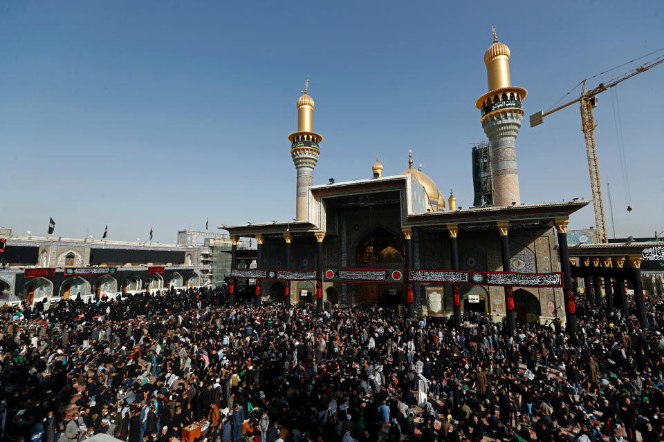 Shiite worshippers gather at the golden-domed shrine of Imam Moussa al-Kadhim, who died at the end of the 8th century, during the annual commemoration of the saint's death, in Baghdad, Iraq, Wednesday, March 10, 2021. (AP Photo/Hadi Mizban)