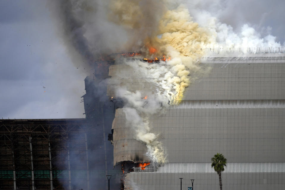 A historic blimp hangar burns in Tustin, Calif., Tuesday, Nov. 7, 2023. A fire Tuesday destroyed a massive World War II-era wooden hangar that was built to house military blimps based in Southern California. (AP Photo/Jae C. Hong)