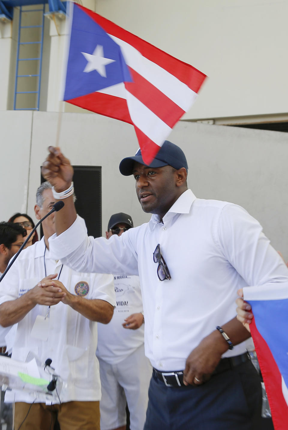 Tallahassee Mayor and Florida Democratic gubernatorial candidate Andrew Gillum holds a Puerto Rican flag at a rally in West Palm Beach, Fla., on Saturday, Sept. 22, 2018, marking the one-year anniversary of Hurricane Maria's devastation of Puerto Rico. (AP Photo/Ellis Rua)