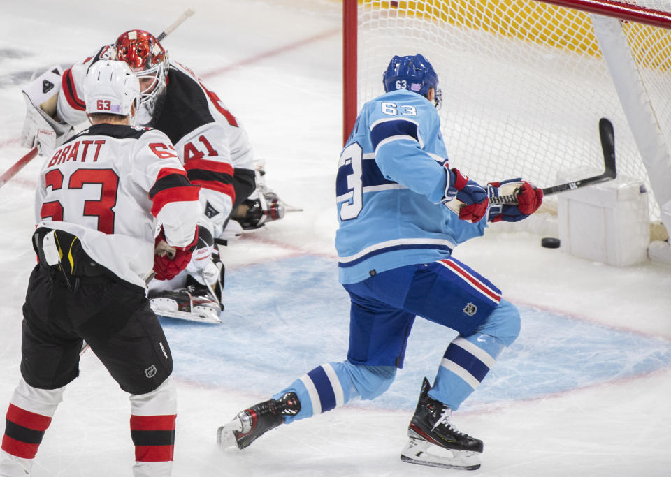 Montreal Canadiens' Evgenii Dadonov (63) scores against New Jersey Devils goaltender Vitek Vanecek as Devils' Jesper Bratt defends during the second period of an NHL hockey game, Tuesday, Nov. 15, 2022 in Montreal. (Graham Hughes/The Canadian Press via AP)