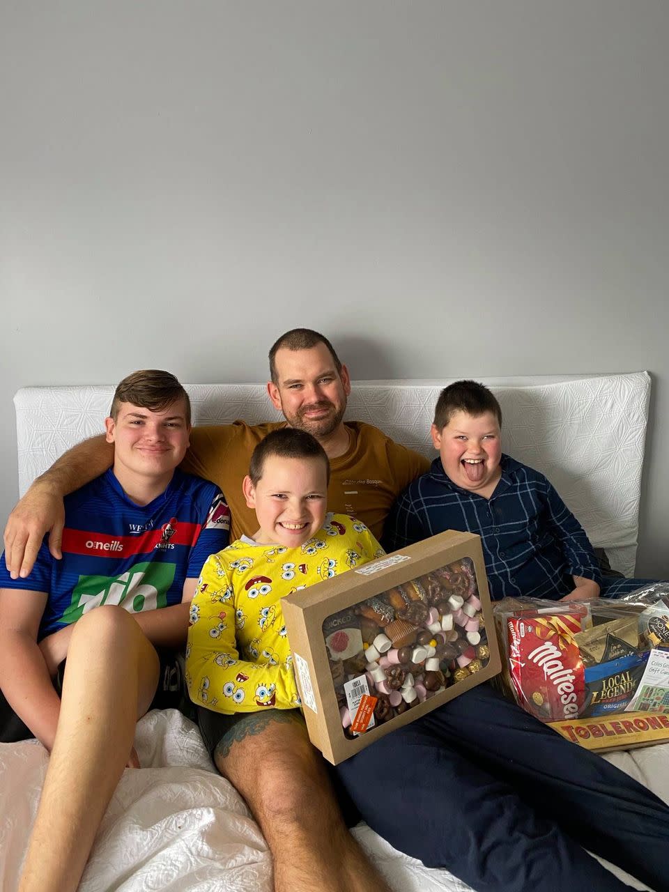 Paul Riddle and his children pose with the Coles Sweet Symphony platter. Source: Facebook.