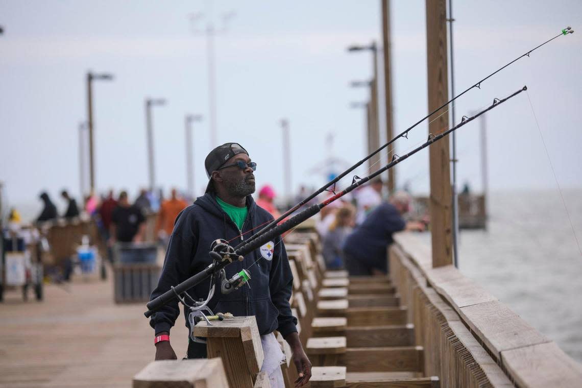 Marese Anthony Odom watches his rods as he fishes from the Springmaid Pier in Myrtle Beach. He and his friends are frequent visitors to Springmaid where they see themselves as ambassadors of the pier culture helping other newcomers to the sport and sharing fish with those less “lucky.” October 10, 2022.