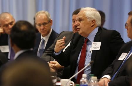 Fred Smith asks a question for U.S. President Barack Obama at the quarterly meeting of the Business Roundtable in Washington, December 3, 2014. REUTERS/Larry Downing