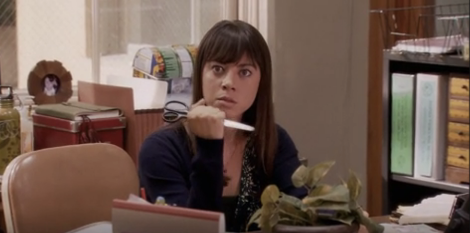 April Ludgate holding scissors up