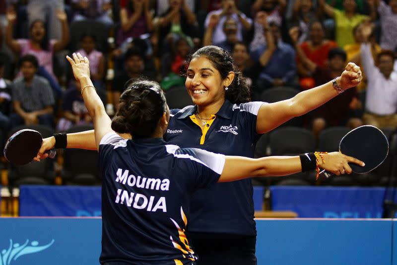 Poulomi Ghatak (R) and Mouma Das (L) of India celebrate winning the Women's Doubles Bronze Medal at 2010 Commonwealth Games. 