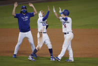 Los Angeles Dodgers' Will Smith, right, gets a virtual high-five from Mookie Betts, center, after Smith drove in the winning run with a single during the 10th inning of the team's baseball game against the Arizona Diamondbacks on Wednesday, Sept. 2, 2020, in Los Angeles. (AP Photo/Marcio Jose Sanchez)