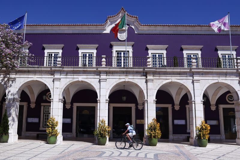 A man passes by the City Hall in Setubal