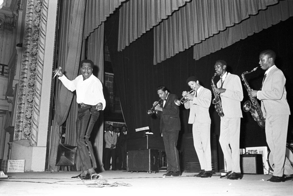 Otis Redding performing on stage during a concert at the Montgomery City Auditorium.