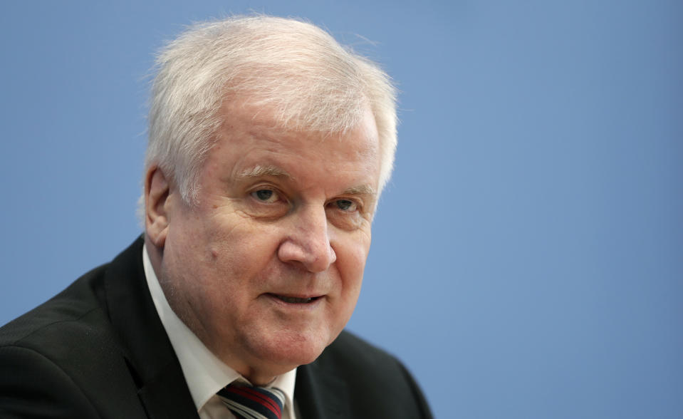 German Interior Minister Horst Seehofer addresses the media during the presentation of the 'Migration Report 2016/17' during a press conference in in Berlin, Germany, Wednesday, Jan. 23, 2019. (AP Photo/Michael Sohn)