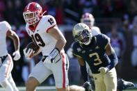 Georgia tight end Brock Bowers (19) outruns Georgia Tech defensive back Tre Swilling (3) for a touchdown after a catch in the first half of an NCAA college football game Saturday, Nov. 27, 2021, in Atlanta. (AP Photo/John Bazemore)