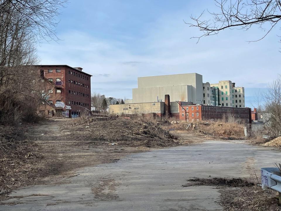The former Great Falls Bleachery and Dye Works mill building in Somersworth still stands at left but some parts of the structure were destroyed by fire in 2019. Developer Eric Chinburg plans to create 145 housing units on the property.