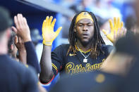 Pittsburgh Pirates' Oneil Cruz is congratulated by teammates after he scored during the fifth inning of a baseball game against the Miami Marlins, Saturday, March 30, 2024, in Miami. (AP Photo/Wilfredo Lee)