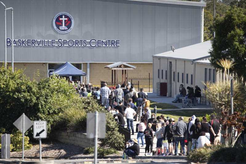 People are seen lining up at the Parklands Christian College's Covid-19 testing clinic, Brisbane.