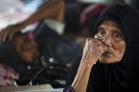 Earthquake survivors rest and reflect at a temporary shelter in Ulim, Aceh province, Indonesia, Friday, Dec. 9, 2016. A large number of people were killed in the quake that hit the northeast of the province on Sumatra before dawn Wednesday. Hundreds of people were injured and thousands buildings destroyed or heavily damaged. (AP Photo/Binsar Bakkara)