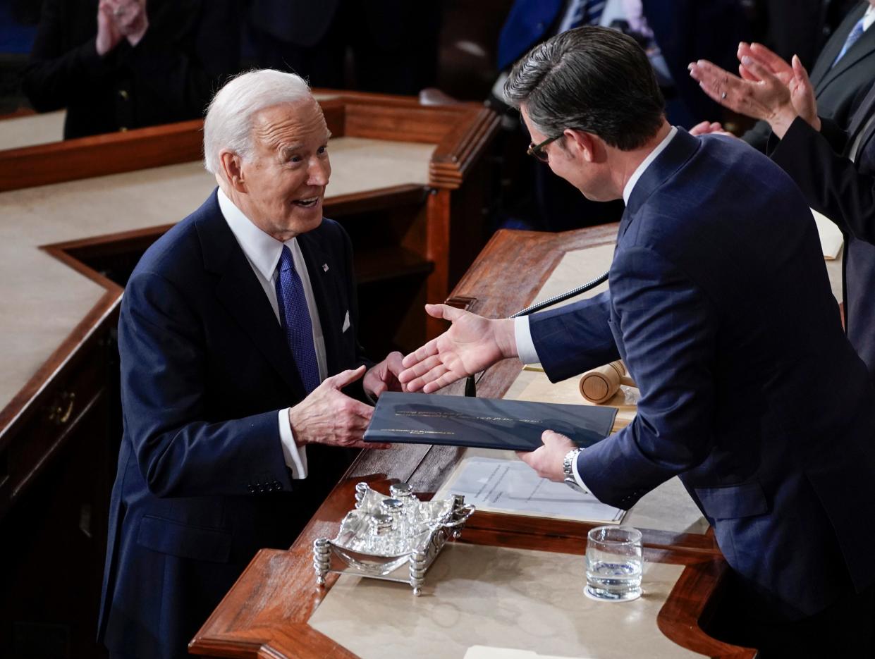 Mar 7, 2024; Washington, DC, USA; President Joe Biden shakes hands with Speaker of the House Mike Johnson before he delivers the State of the Union address to Congress at the U.S. Capitol in Washington on March 7, 2024. Mandatory Credit: